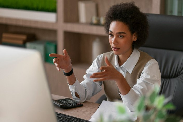 woman sitting behind the laptop on a conference call